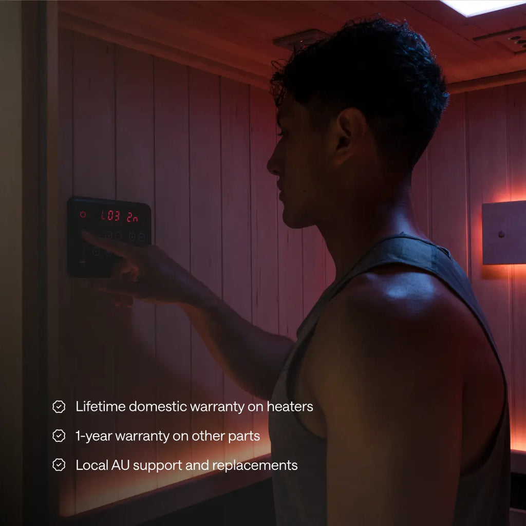 A man adjusts a Kiva Wellness sauna control panel beneath warranty and Australian support information.