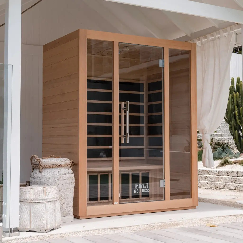 Timber Kiva Wellness sauna beneath a white garden pavilion beside baskets and folded towels.