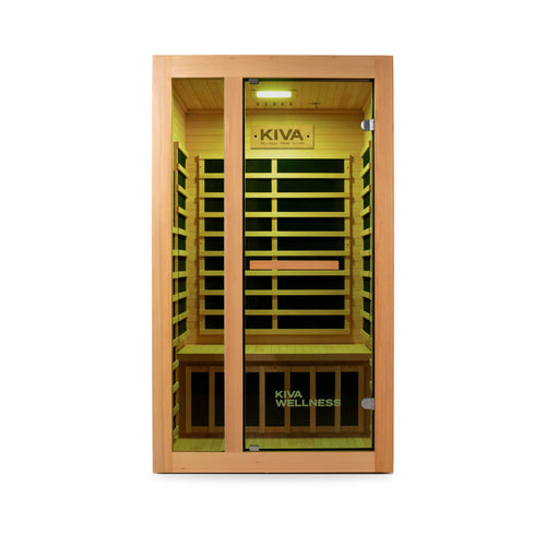 A Kiva wellness infrared sauna cabinet with a light wood exterior, glass doors, and a warm yellow interior, shown against a plain white background.