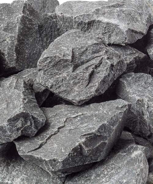 Close view of rough grey sauna stones.