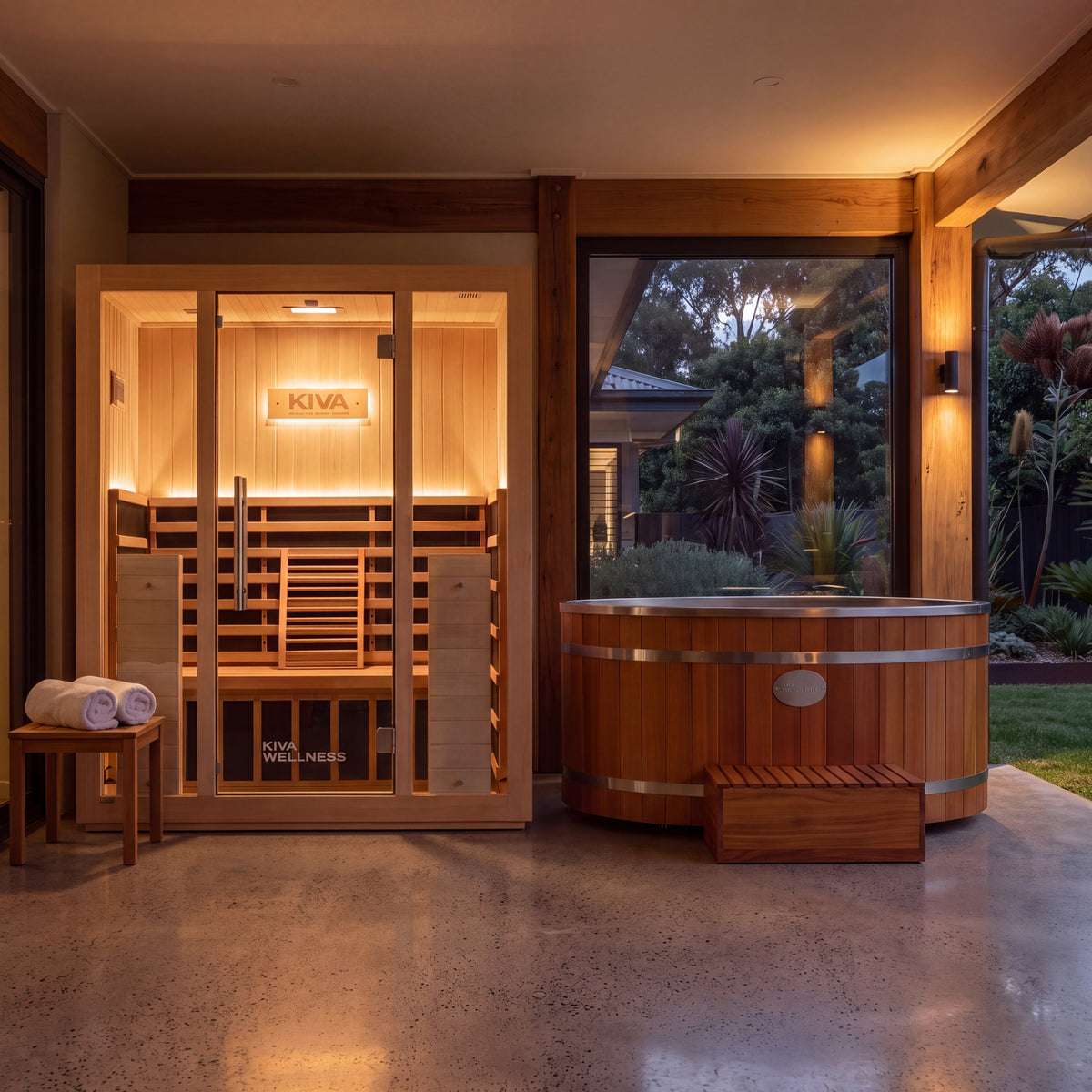 Kiva Wellness Radiance Pro sauna and Energise cedar ice bath displayed together on a sheltered patio at dusk.