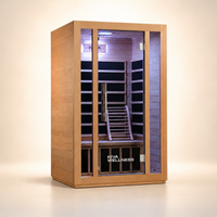 A Kiva Wellness infrared sauna with a light natural wood exterior, glass door, and a dark interior with wooden benches and a backrest, shown on a clean beige studio background.