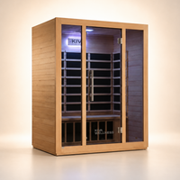 A Kiva Wellness wooden infrared sauna with glass door, interior wood bench, and purple ambient lighting, shown on a clean beige studio background.