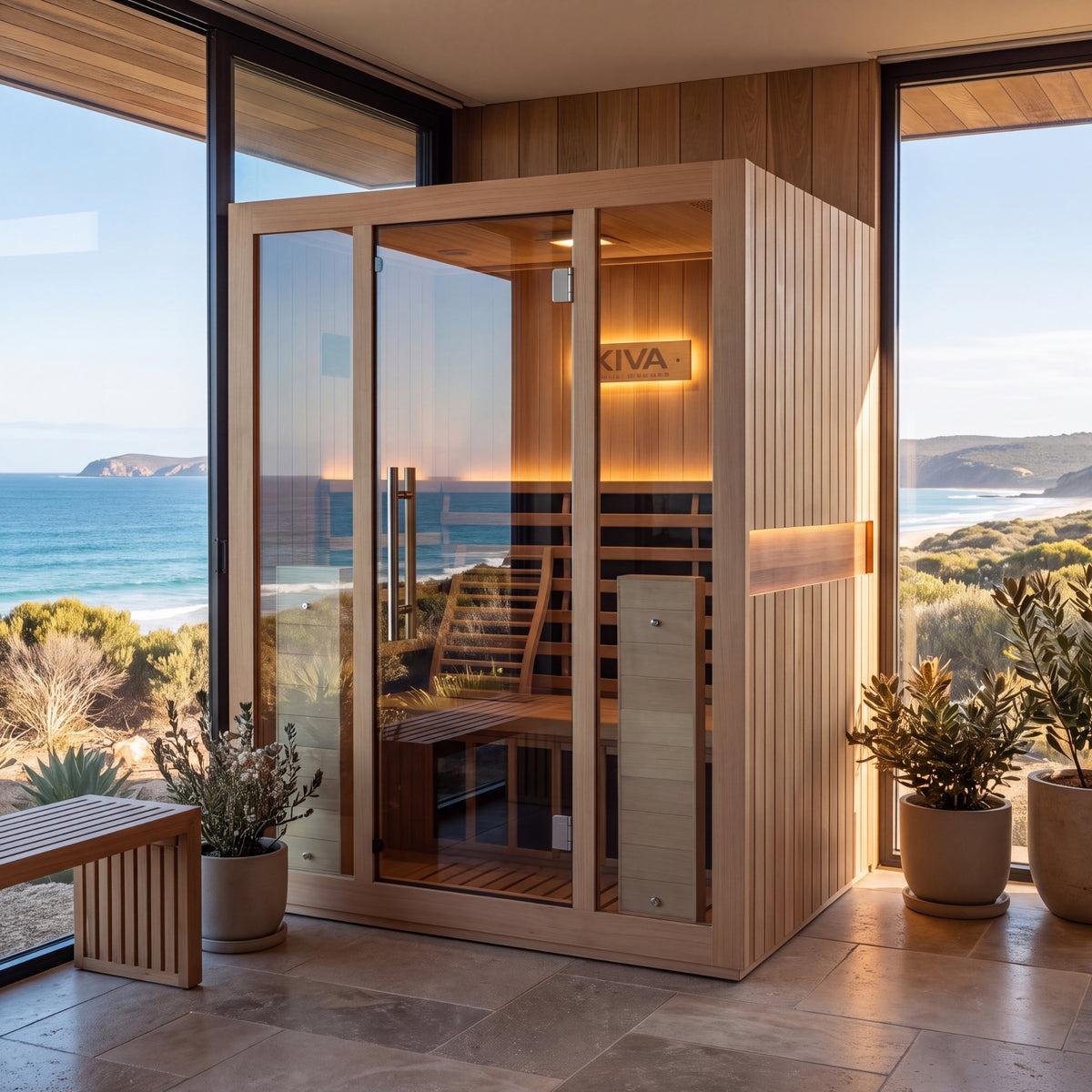 Radiance Pro 3 Person Full Spectrum Infrared WiFi Sauna, situated in a sunlit room with large windows overlooking a coastal ocean view