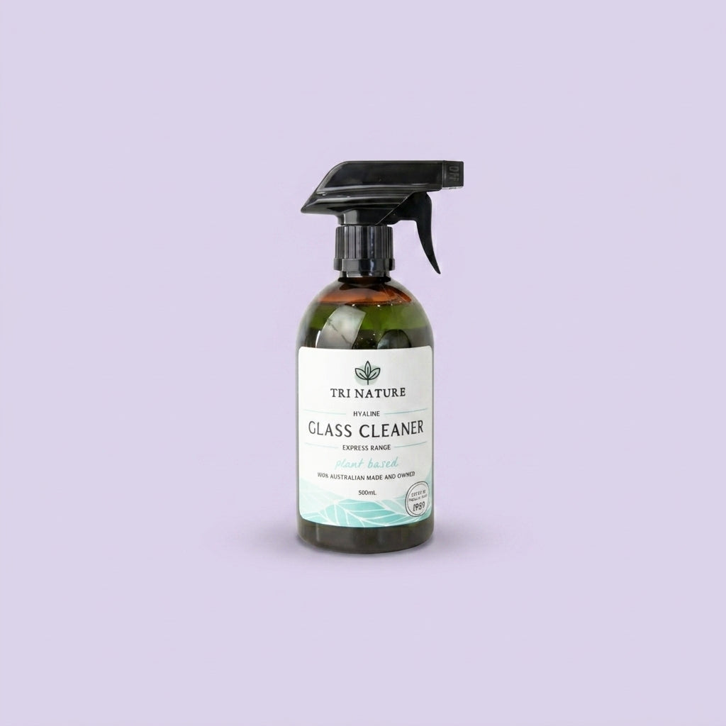 A 500ml spray bottle of Tri Nature Glass Cleaner set against a solid lavender background.