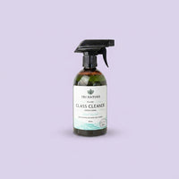 A 500ml spray bottle of Tri Nature Glass Cleaner set against a solid lavender background.